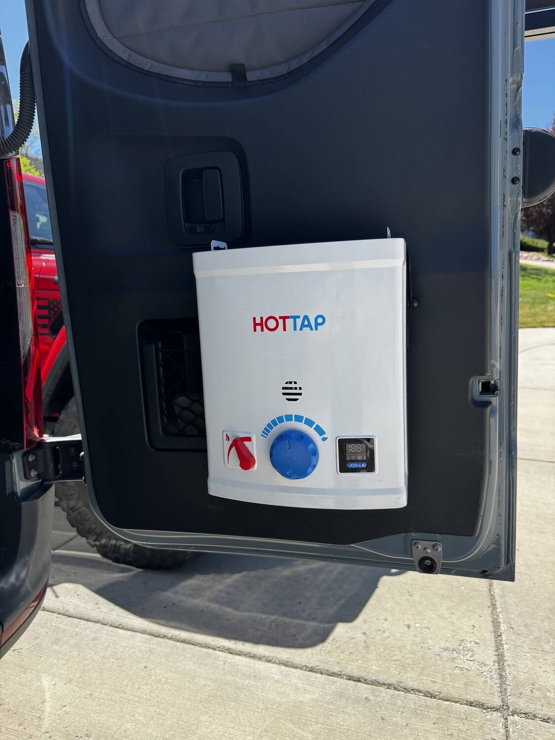 Joolca HotTap V2 mounted to the inside of the rear door, ready for an outdoor shower