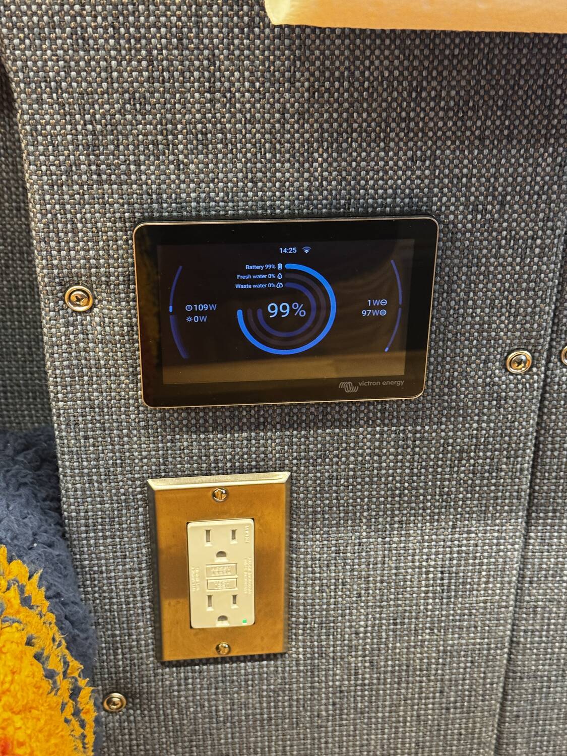 Cerbo GX wall-mounted above a Leviton GFCI outlet showing 109W shore in and 97W DC load