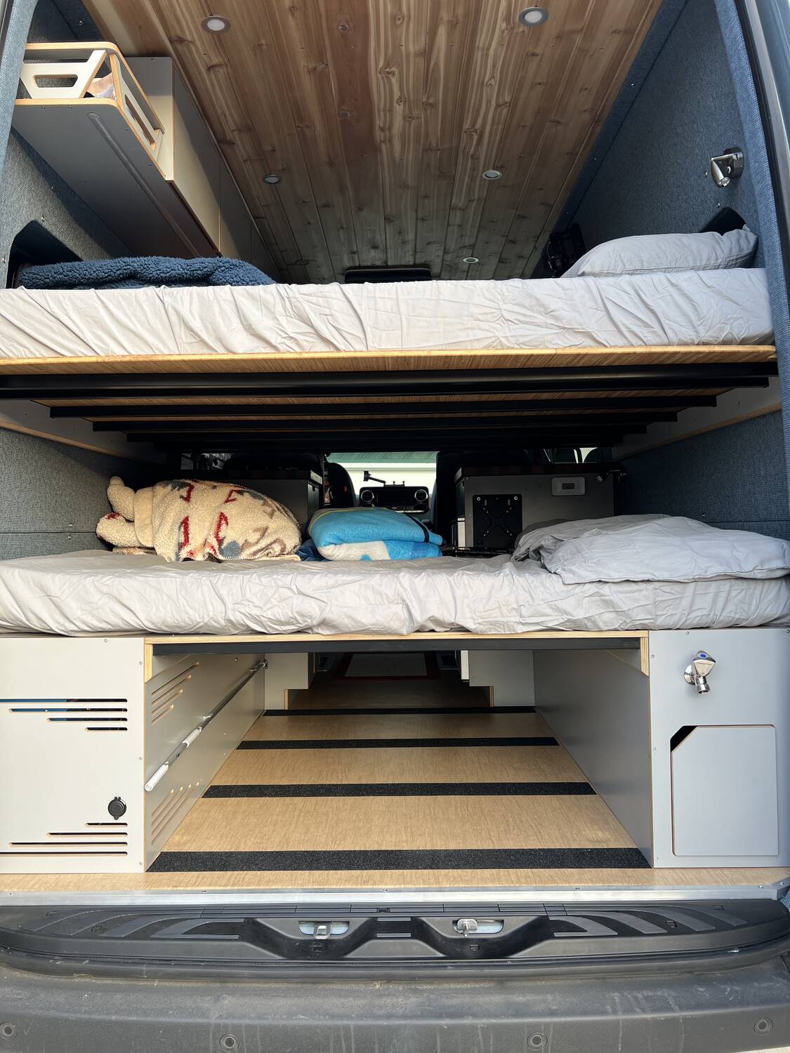 Under-bunk storage open showing pull-out drawer and gear bay