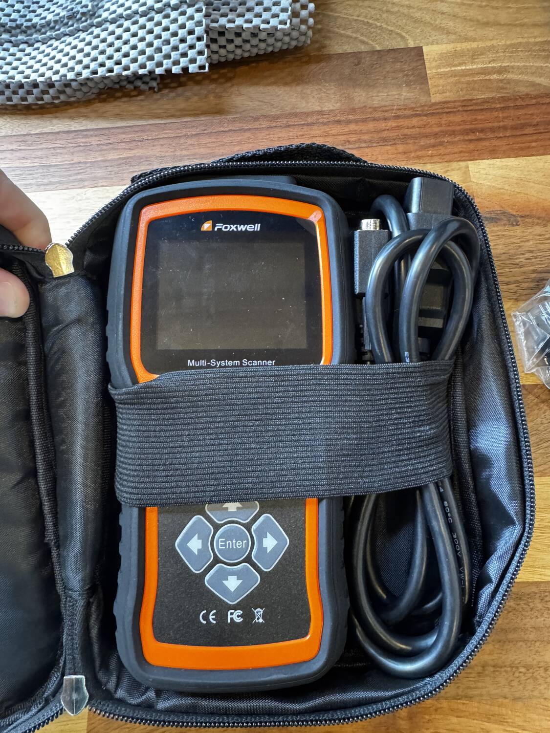 Foxwell multi-system OBD-II diagnostic scanner in zippered case with OBD cable