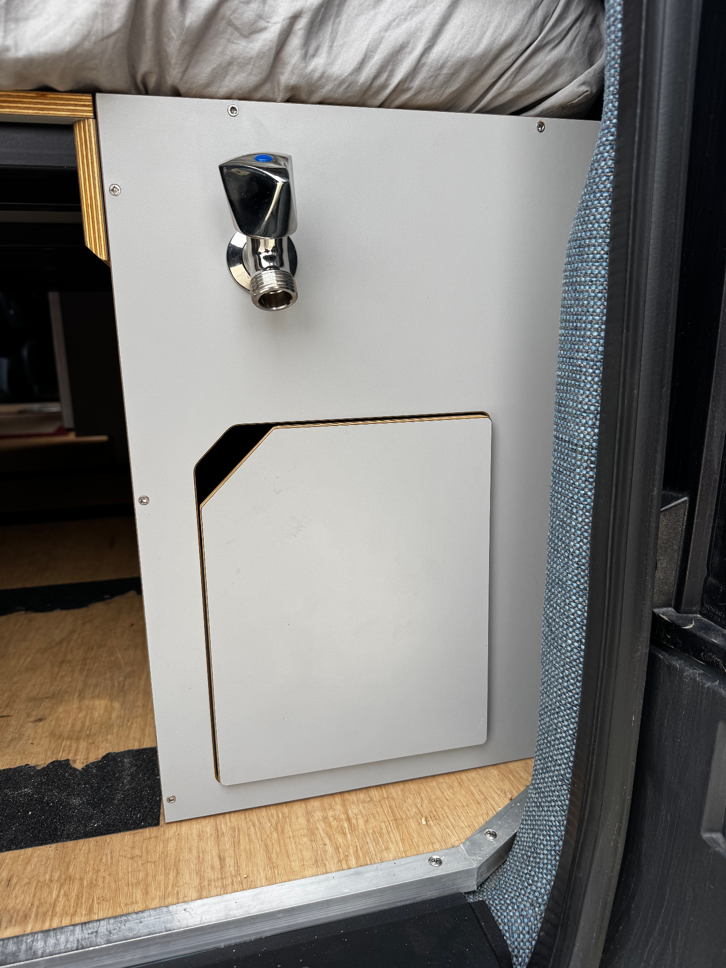 Water cabinet with access door closed, faucet fitting above