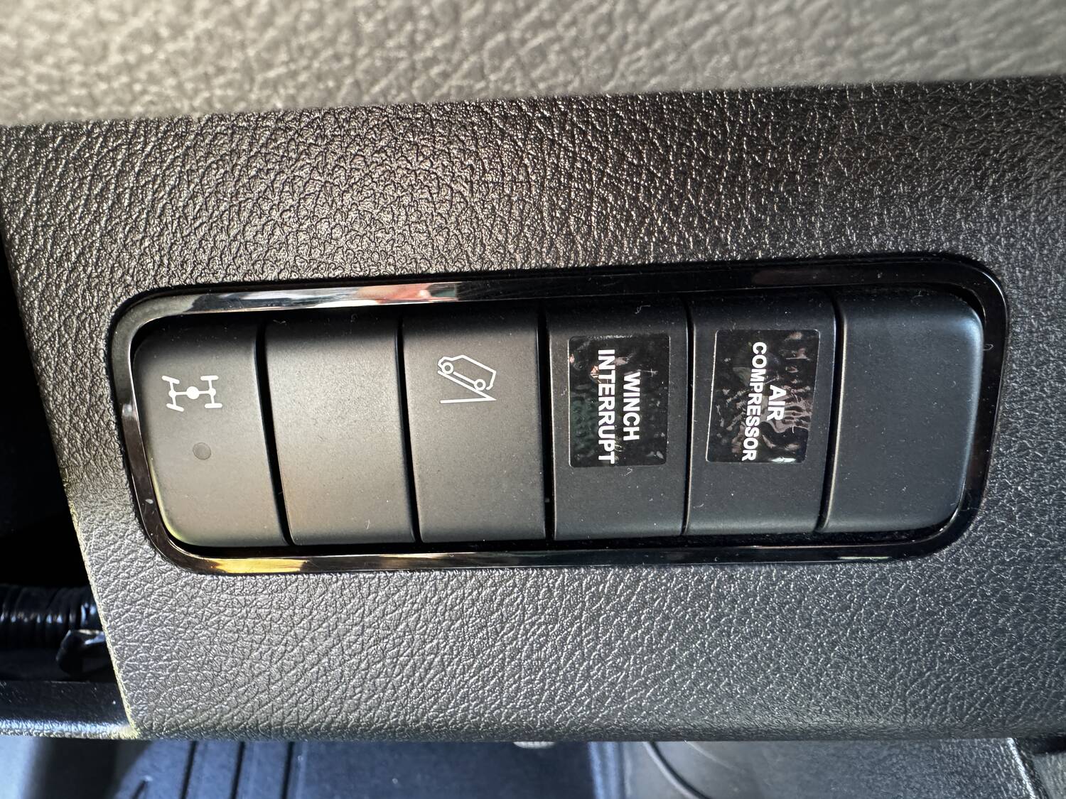 Dash switch panel: 4x4 low range, sway disconnect, winch interrupt and ARB air compressor
