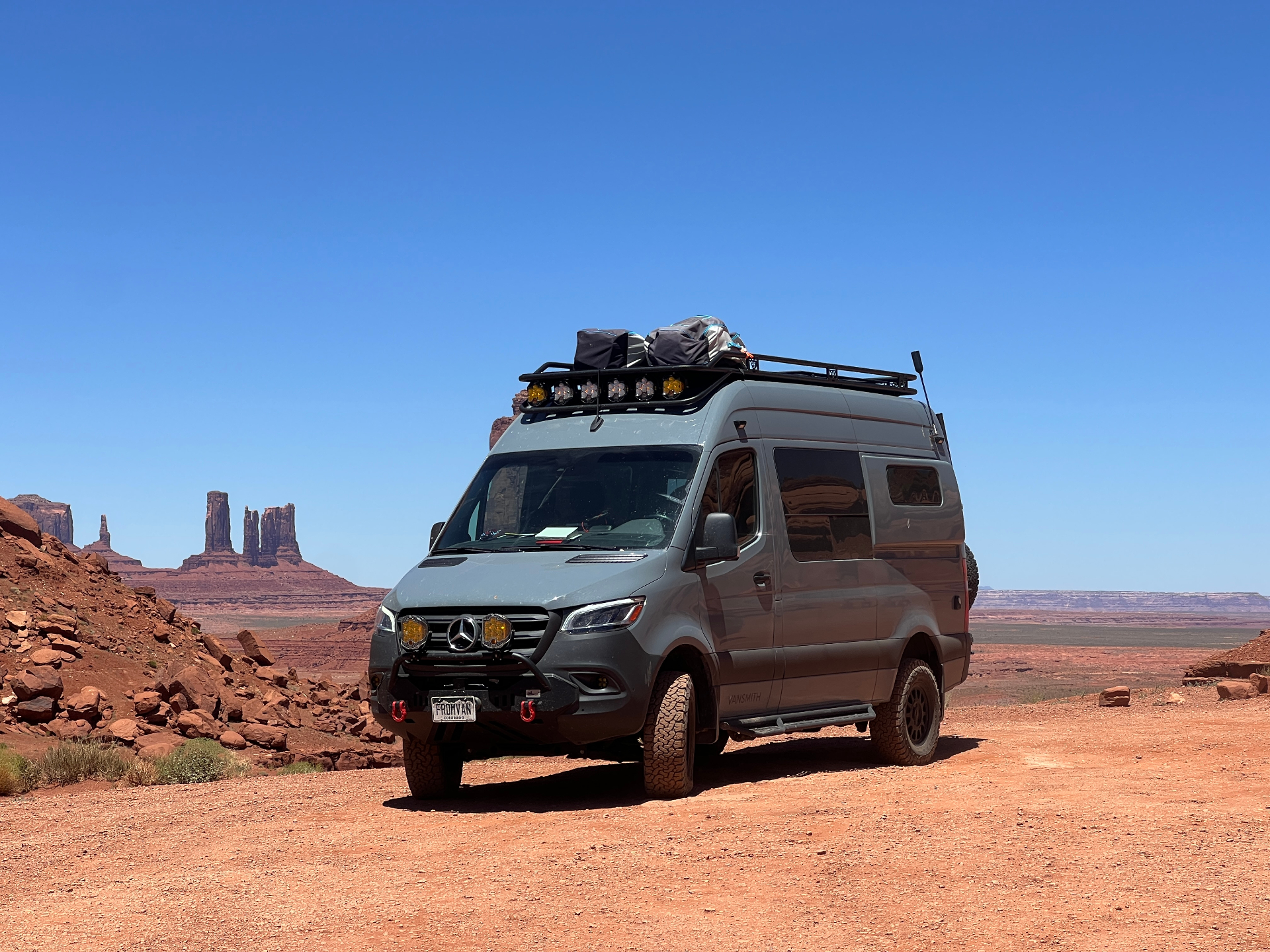 Sprinter loaded for travel in Monument Valley at golden hour