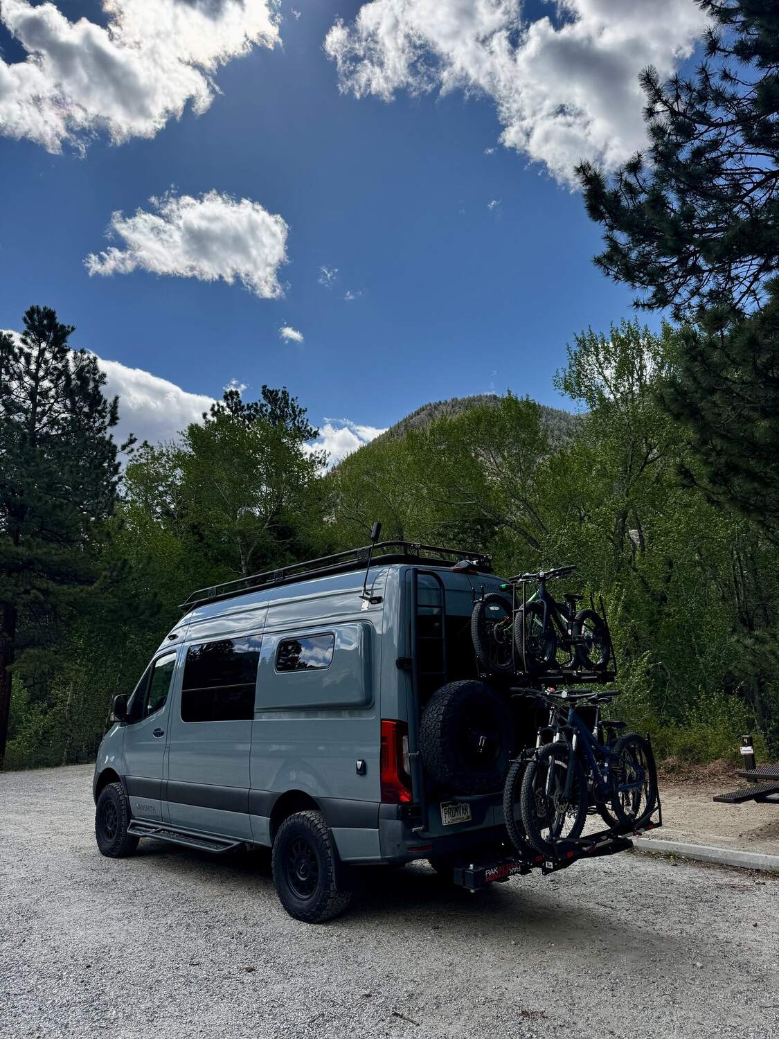 Rear-quarter view of the Sprinter with spare tire and full bike rack