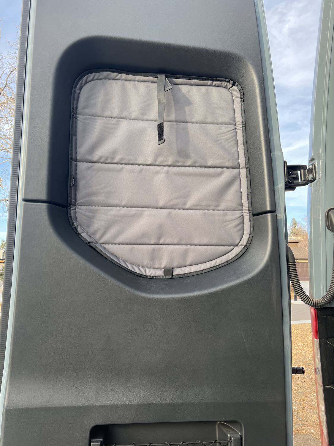 Van Essential insulated blackout window cover installed on the rear door window